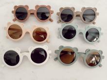 Children's sunglasses with teddy bear ears on outside of the frame for each lens