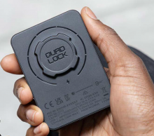 Quad lock MAG battery pack Black rectangular electronic device held in the palm of a hand.