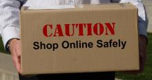 Cardboard box with text caution shop online safely