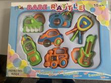 This is a photograph of the Dimmeys Babe Rattle 7 piece set in the box as sold.