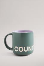 Mid-green coloured mug with purple interior colour and white Country Road branding
