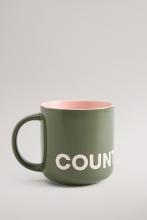 Dark green coloured mug with yellow interior colour and white Country Road branding
