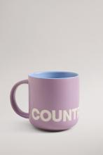 Lilac coloured mug with blue interior colour and white Country Road branding