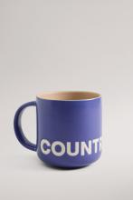 Sapphire coloured mug with yellow interior colour and white Country Road branding