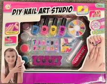 The front of the DIY nail art studio packaging, depicting the products inside and several suggested uses