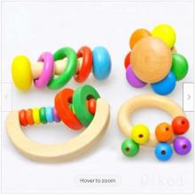 photograph of set of 4 Montessori wooden rattles and teethers for babies